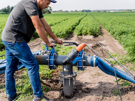 Adult male pumping groundwater for crops.