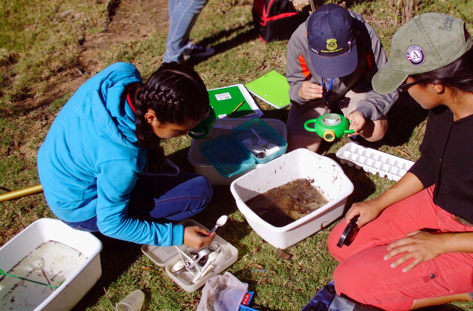students testing river water